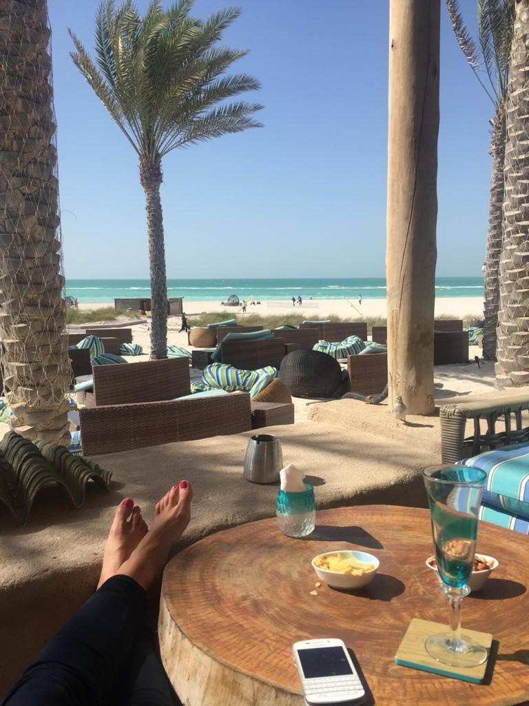 After work feet up relaxing drink by the beach