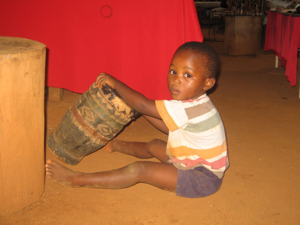 Little African boy playing drums